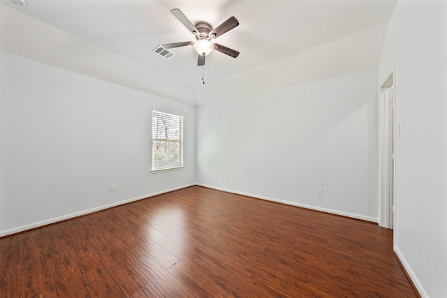 unfurnished room with dark wood-style floors, ceiling fan, visible vents, and baseboards