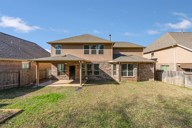 rear view of house featuring a fenced backyard, a patio, a lawn, and brick siding