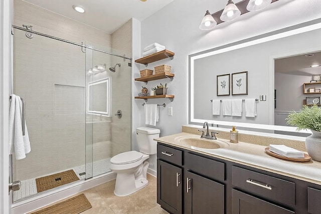 full bath with a stall shower, tile patterned flooring, vanity, and toilet