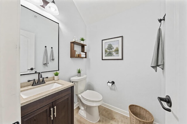 bathroom featuring baseboards, vanity, toilet, and tile patterned floors