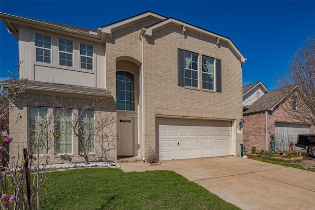 traditional home with driveway, an attached garage, a front lawn, and brick siding