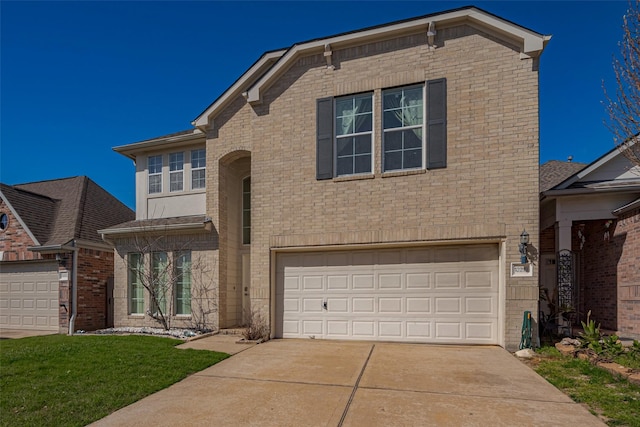 traditional-style house featuring concrete driveway, brick siding, and an attached garage