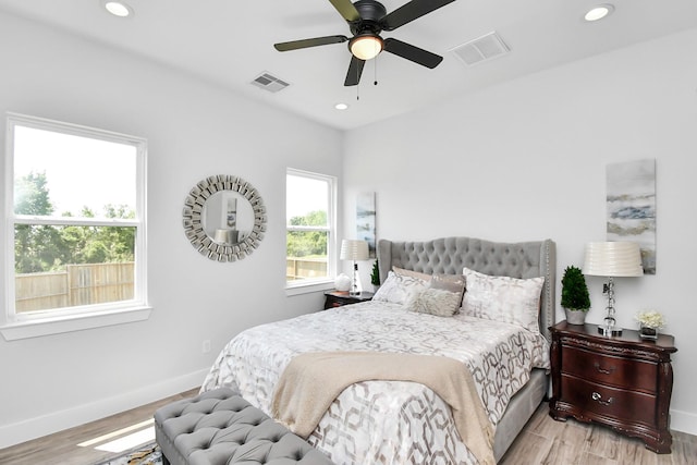 bedroom featuring baseboards, visible vents, wood finished floors, and recessed lighting