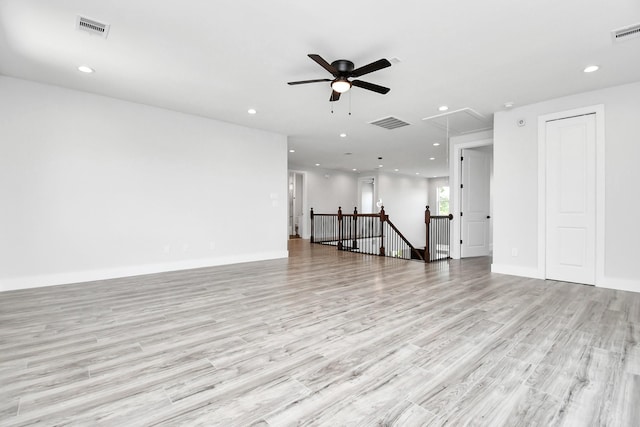 unfurnished room with attic access, visible vents, and recessed lighting