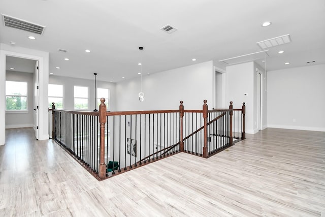 hall with attic access, recessed lighting, visible vents, and an upstairs landing