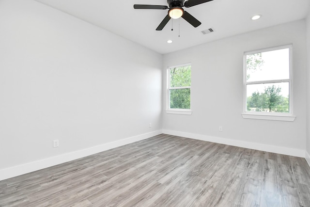 empty room with baseboards, visible vents, ceiling fan, wood finished floors, and recessed lighting