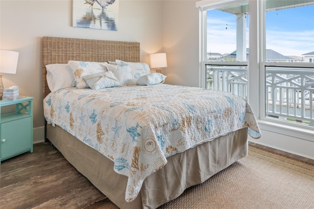 bedroom featuring wood finished floors and baseboards