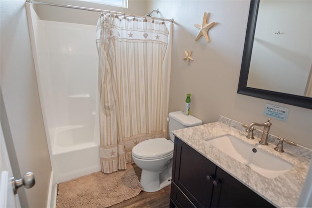 bathroom featuring shower / bath combination with curtain, vanity, toilet, and wood finished floors