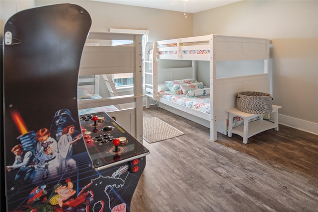 bedroom featuring wood finished floors and baseboards