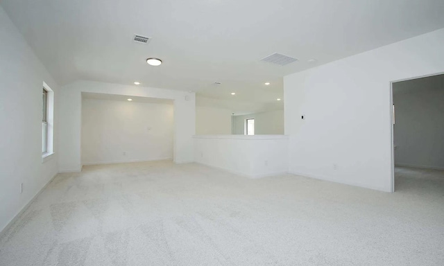 empty room with visible vents, carpet flooring, and recessed lighting