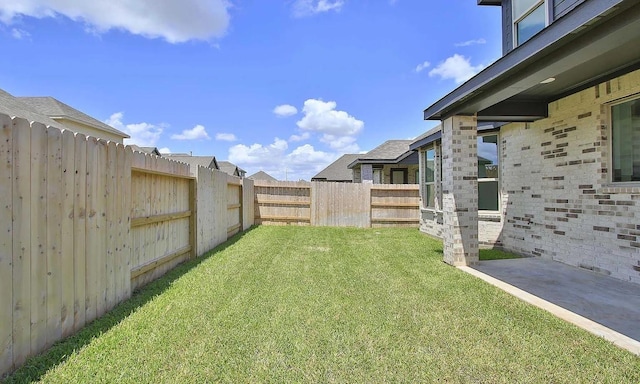 view of yard with a fenced backyard