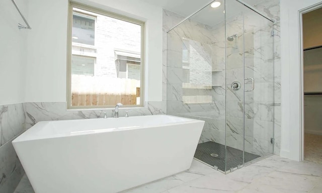 bathroom with recessed lighting, marble finish floor, a soaking tub, and a marble finish shower