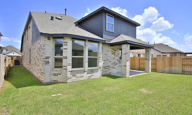 back of property featuring a yard, central air condition unit, a shingled roof, crawl space, and a fenced backyard