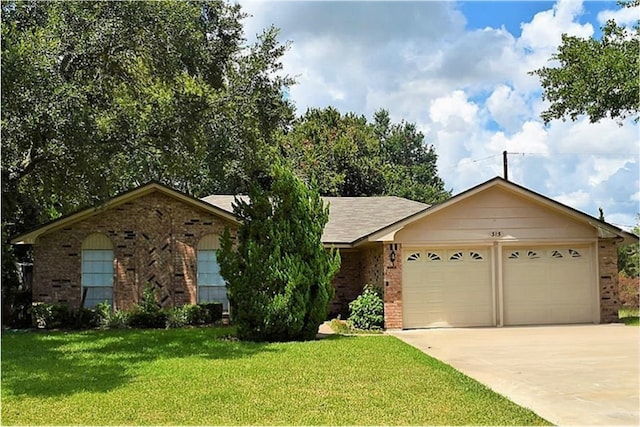 ranch-style home with a garage, a front yard, concrete driveway, and brick siding