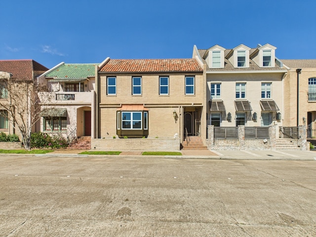 townhome / multi-family property featuring brick siding and a balcony