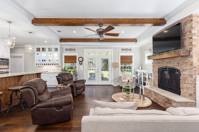 living room with dark wood-style floors, ornamental molding, beam ceiling, and french doors