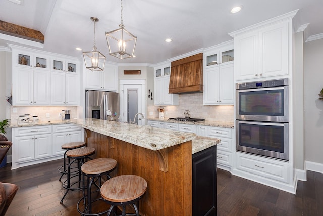 kitchen featuring custom exhaust hood, white cabinetry, appliances with stainless steel finishes, and dark wood-type flooring