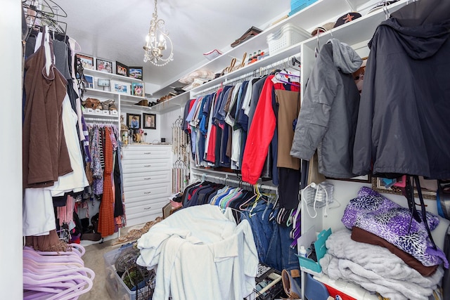 walk in closet featuring an inviting chandelier