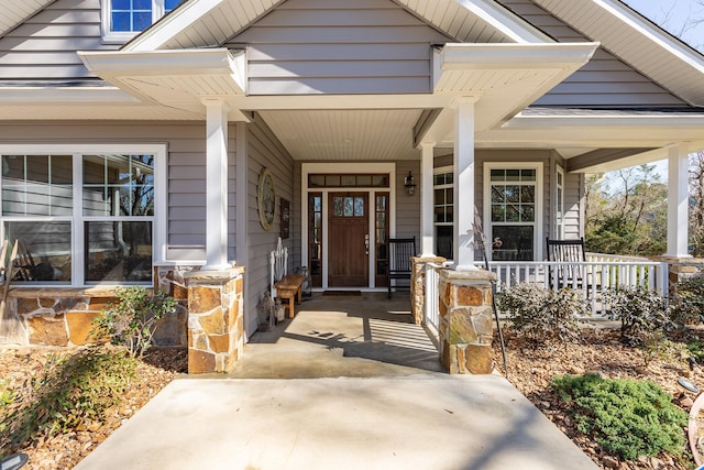 view of exterior entry featuring a porch