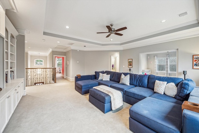 living area with ornamental molding, a raised ceiling, visible vents, and recessed lighting