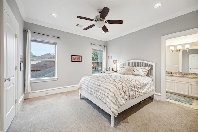 bedroom with crown molding, light colored carpet, visible vents, ensuite bath, and baseboards