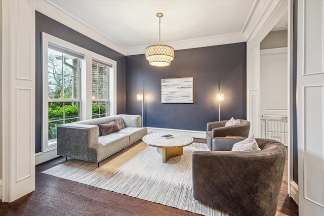 living room featuring ornamental molding and wood finished floors