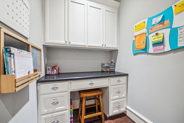 office area with built in study area and baseboards