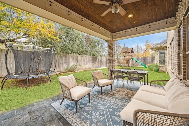 view of patio featuring a ceiling fan, a fenced backyard, an outdoor hangout area, a trampoline, and a playground