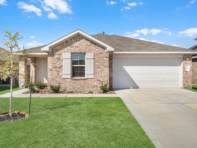 ranch-style home featuring a garage, a shingled roof, concrete driveway, a front lawn, and brick siding