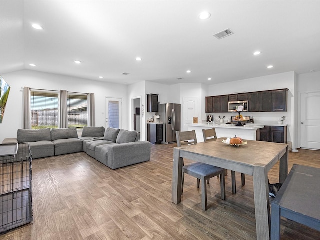 dining space featuring light wood-style floors, recessed lighting, and visible vents