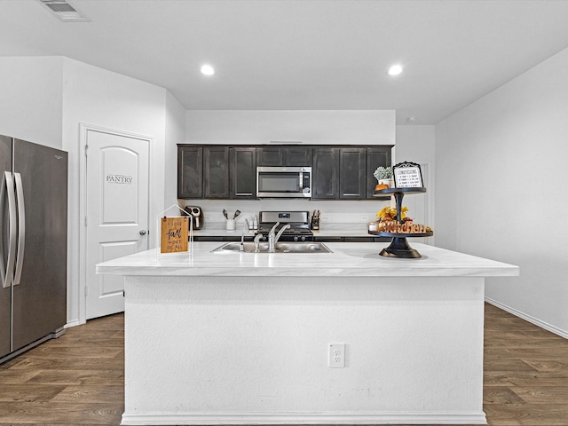 kitchen with visible vents, appliances with stainless steel finishes, dark wood-style flooring, light countertops, and a sink