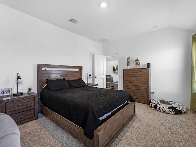 bedroom with carpet floors, visible vents, and vaulted ceiling