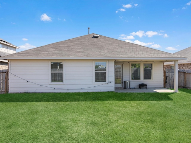 back of property featuring a patio area, fence, a lawn, and roof with shingles