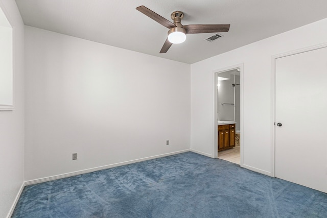 unfurnished bedroom featuring ceiling fan, connected bathroom, light carpet, visible vents, and baseboards