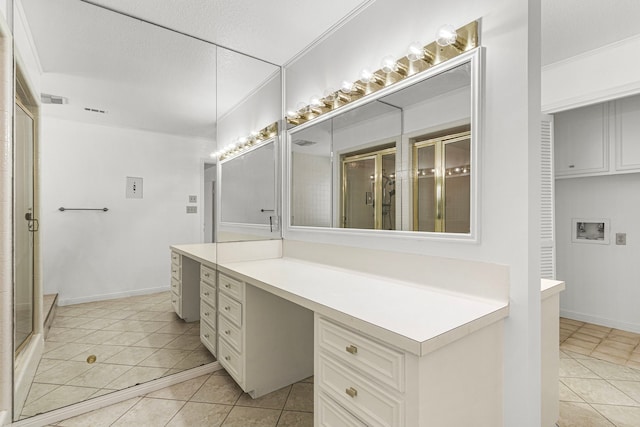 bathroom featuring visible vents, tile patterned flooring, crown molding, vanity, and a shower stall