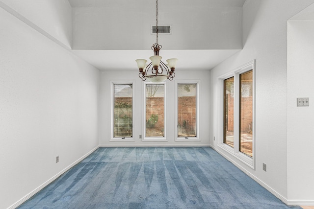 interior space featuring visible vents, a notable chandelier, and baseboards