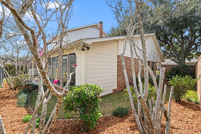 view of property exterior featuring brick siding