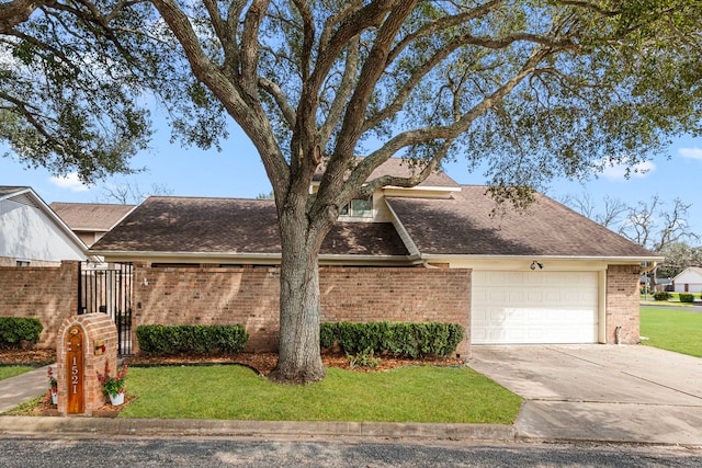 view of front of property featuring an attached garage, brick siding, concrete driveway, roof with shingles, and a front yard