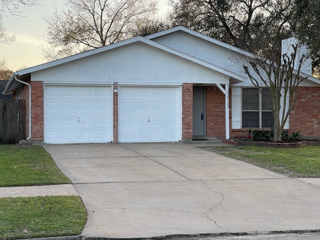 ranch-style house with concrete driveway, brick siding, and an attached garage