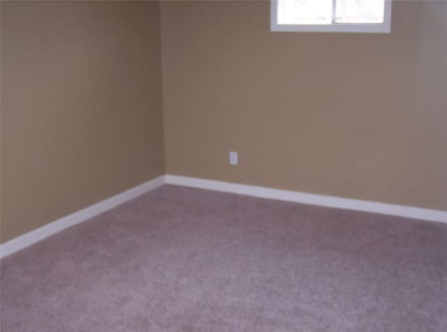 spare room with carpet floors and baseboards