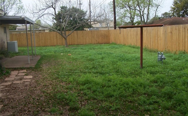 view of yard featuring central AC and a fenced backyard