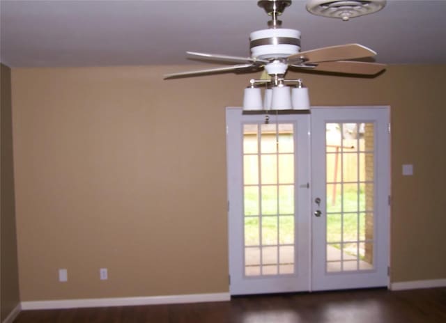 doorway featuring ceiling fan, baseboards, wood finished floors, and french doors