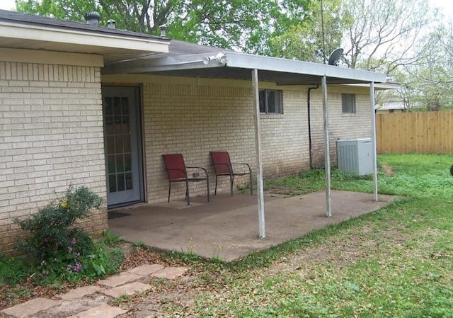 view of patio / terrace with central AC and fence