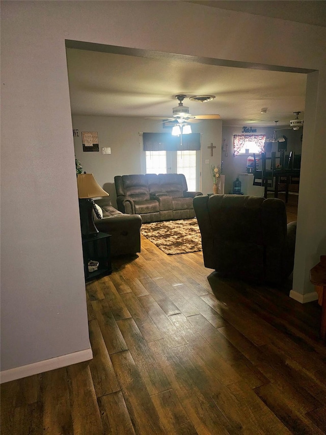 living area with visible vents, wood finished floors, and ceiling fan