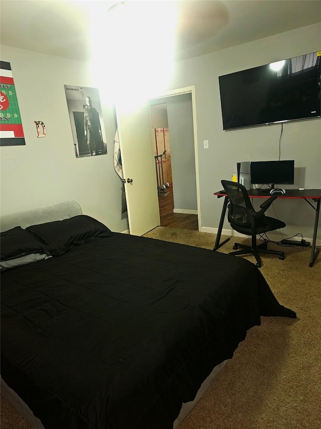 carpeted bedroom featuring baseboards