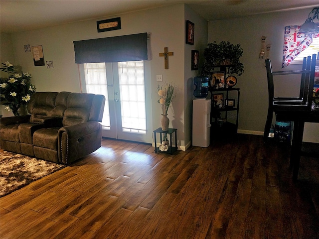 living area featuring baseboards, french doors, and wood finished floors