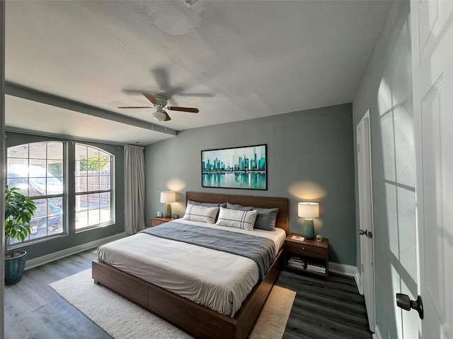 bedroom featuring a ceiling fan, baseboards, and wood finished floors