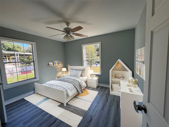 bedroom with wood finished floors, a ceiling fan, and baseboards