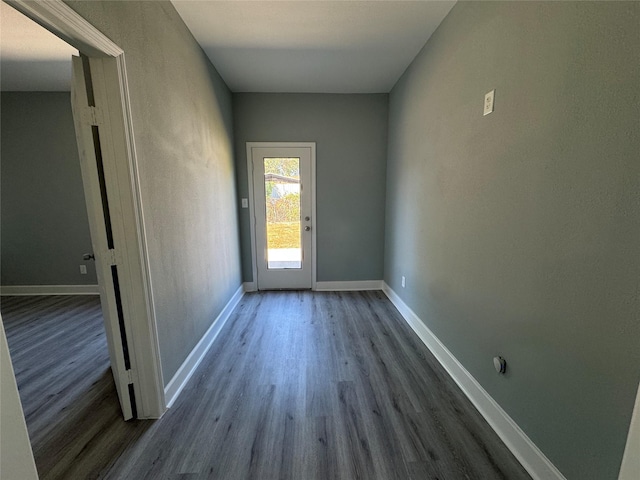 entryway with baseboards and wood finished floors