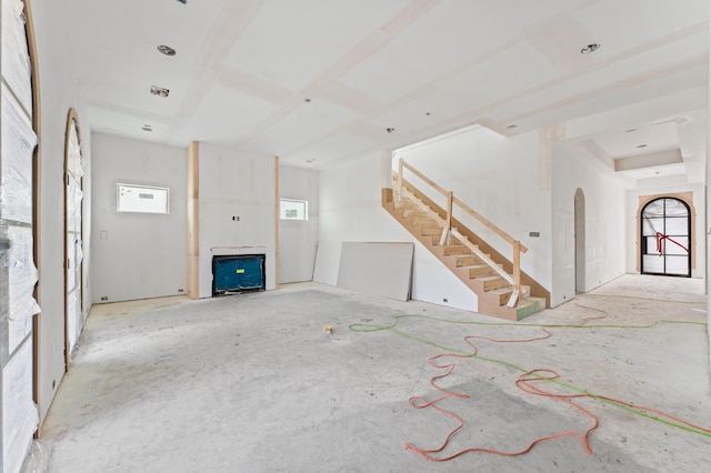 unfurnished living room with stairs